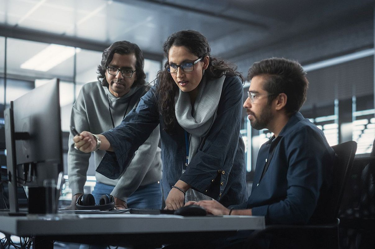 Three people analyzing data